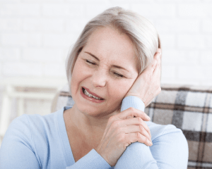 Woman in discomfort holding her face due to her trigeminal nerve