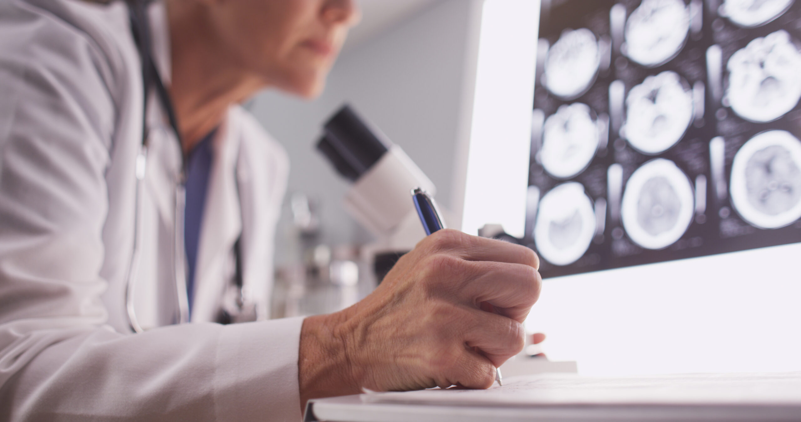 Medical researcher examining brain scan imagery.