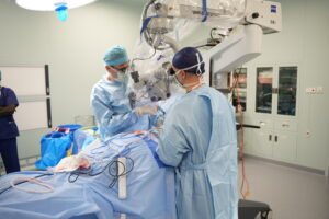 Surgical team conducting a complex surgical procedure in theatre room.