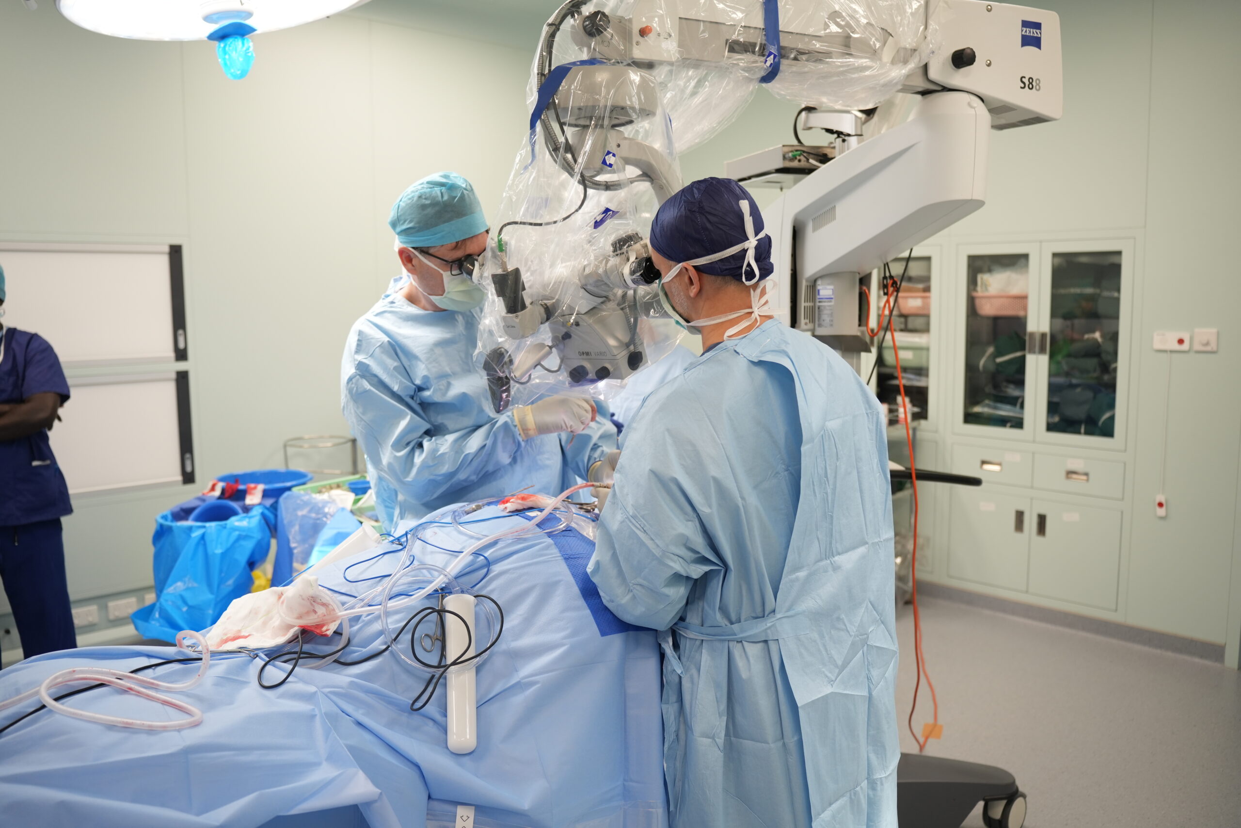 Surgical team conducting a complex surgical procedure in theatre room.